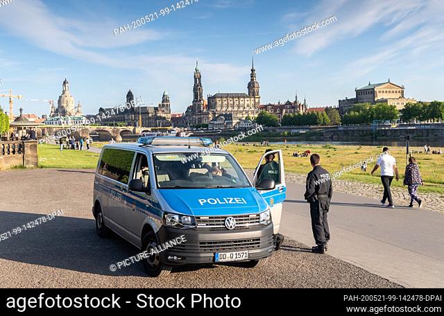 21 May 2020, Saxony, Dresden: On Father's Day, also known as Men's Day, policemen patrol the Elbe Cycle Route against the historical backdrop of the Old Town...