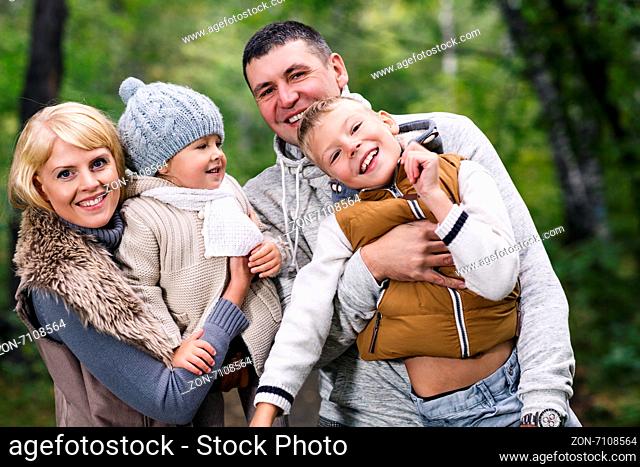 Close up portrait of a young family in the autumn park