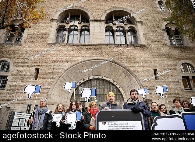 21 November 2023, Berlin: Supporters of the lawsuit stand in front of the Berlin Regional Court before the start of the hearing of DUH's landmark lawsuit...