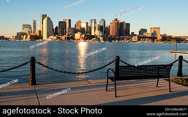 Light reflects of the glass in buildings in the urban downtown city center core skyline of Boston Massachusetts