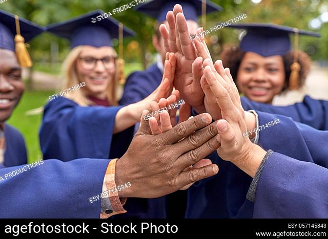 international graduate students making high five