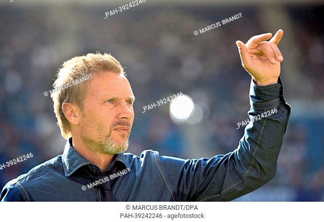 Head coach of Bundesliga soccer club Hamburger SV, Thorsten Fink, waves to fans before the Bundesliga soccer match between Hamburger SV and VfL Wolfsburg at...