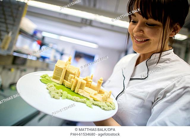 Confectioner and food technology student Anne-Sophie Busch holds a marzipan model of Neuschwanstein Castle, in the rooms of the start up business 'Print2Taste'...