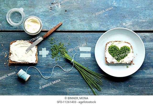 An equation showing how to make bread with cream cheese and a chive heart