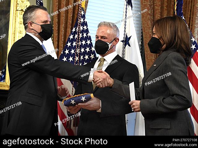 United States Vice President Kamala Harris (R) shakes hands with the State Department's Chief of Protocol Rufus Gifford (L) after swearing him in as his husband...