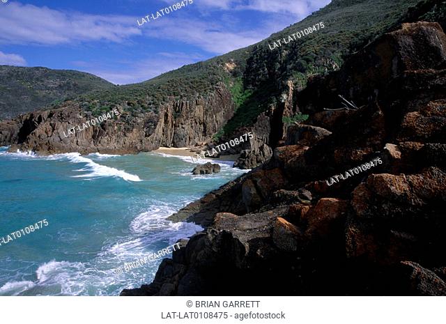Tomaree headland is on the coastline near Newcastle and Port Stephens. Steep cliffs drop to the water. There is an isolated beach under the cliffs