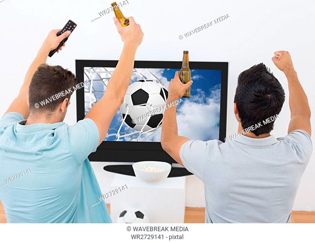 Two excited men cheering with beer bottle while watching sport match on tv