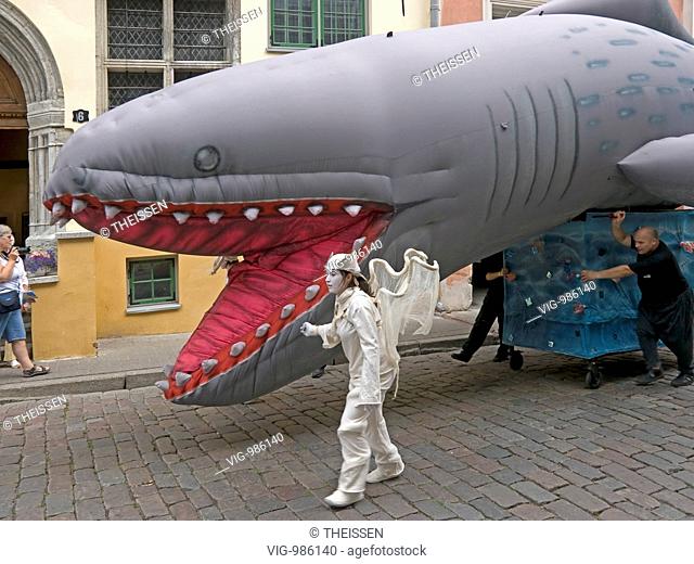 people celebrating friends from Catalonia, Catalonian festival with traditional festive procession with big imaginative figures with a shark in the streets of...