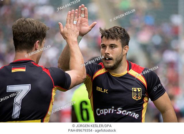 Fabian Heimpel and Phil Szczesny high-five during the qualification match between Germany and Uganda at the HSBC World Rugby Sevens Series in Hongkong, China