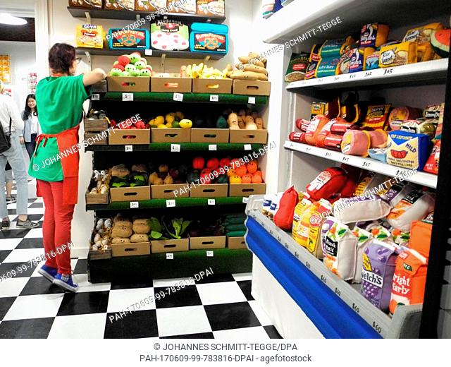 British artist Lucy Sparrow works inside her grocery store '8 'till late' in which everything is made out of felt in New York, United States, 08 June 2017