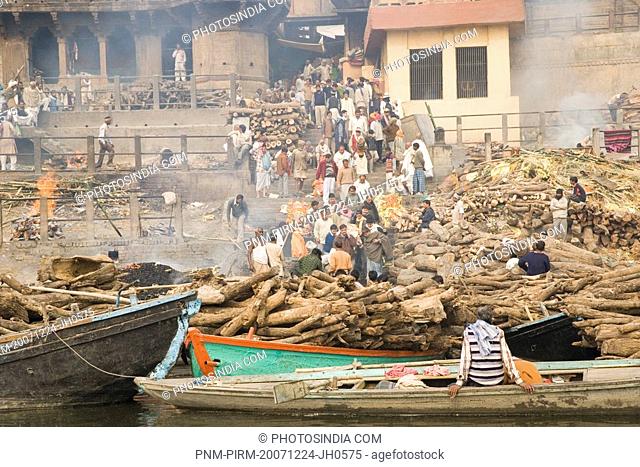 Firewood on the boats with cremation of dead bodies at a ghat, Manikarnika Ghat, Ganges River, Varanasi, Uttar Pradesh, India