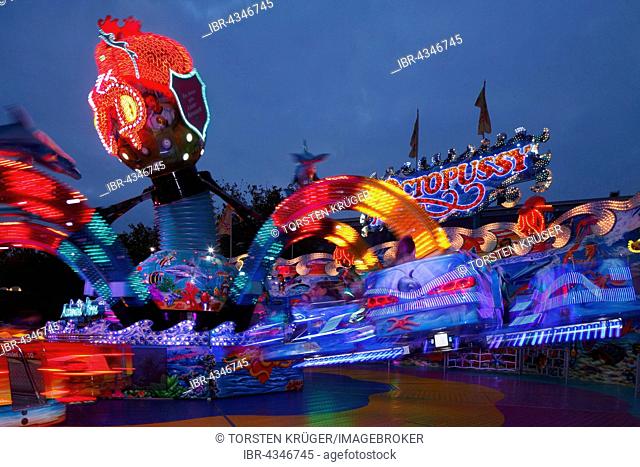 Octopussy ride on the fun fair Bremer Freimarkt at dusk, Bremen, Germany