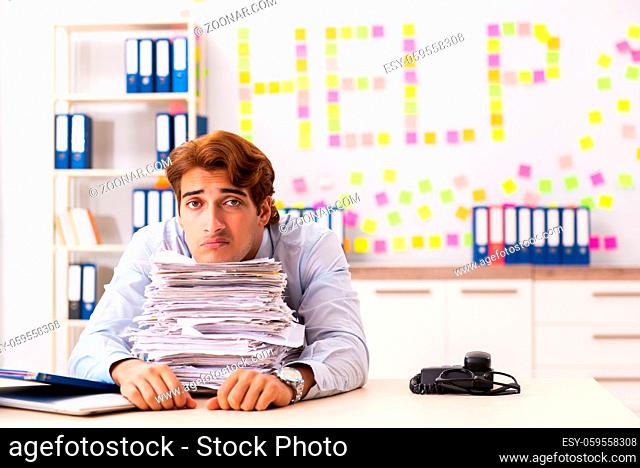 Young employee suffering from excessive work