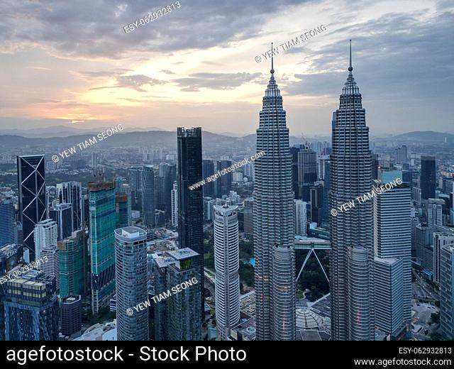Bukit Bintang, Kuala Lumpur, Malaysia - Dec 25 2022: The city's iconic landmarks the KLCC Petronas Twin Towers in sunrise