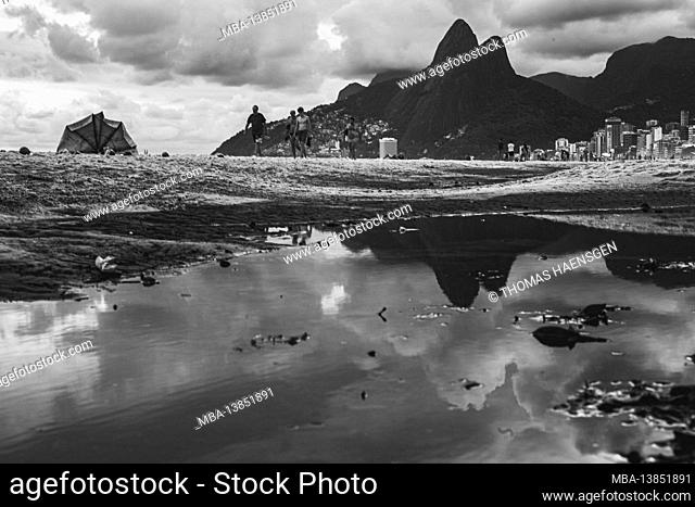 Big Puddle of water after rain reflecting Two Brothers Mountain (Dois Irmaos) at the beach of Ipanema/Leblon in Rio de Janeiro, Brazil. Leica M10
