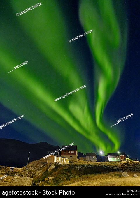 Northern Lights over settlement Kuummiit (formerly spelled Kummiut). Ammassalik area in East Greenland. North America, Greenland, Danish Territorrry