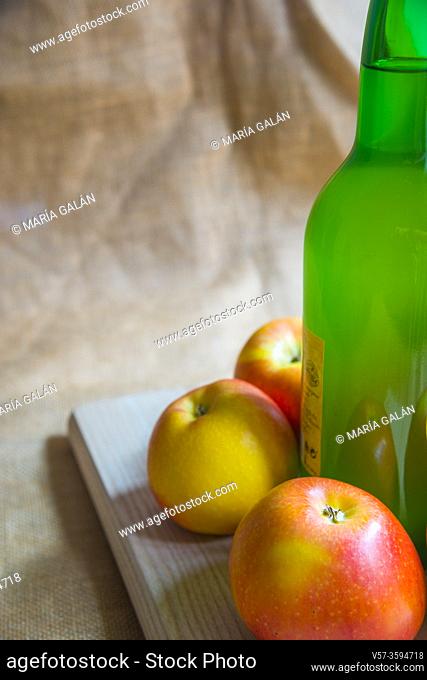 Bottle of cider with apples, close view. Asturias, Spain
