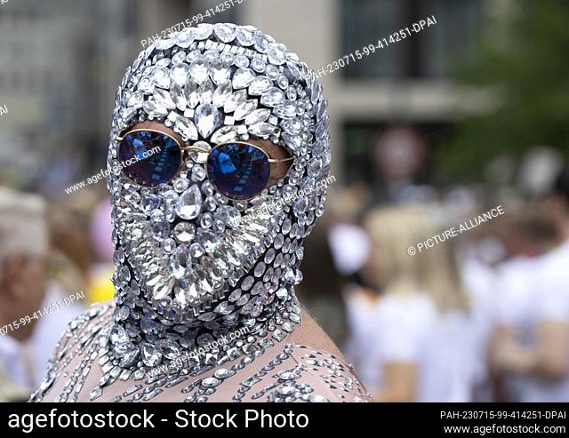 dpatop - 15 July 2023, Hesse, Frankfurt/Main: Colorfully costumed participant of the CSD moves through the city center. Traffic in the downtown area came to a...