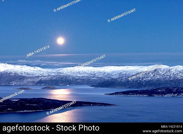 The full moon over the wintry Kvaenangenfjord in Norway