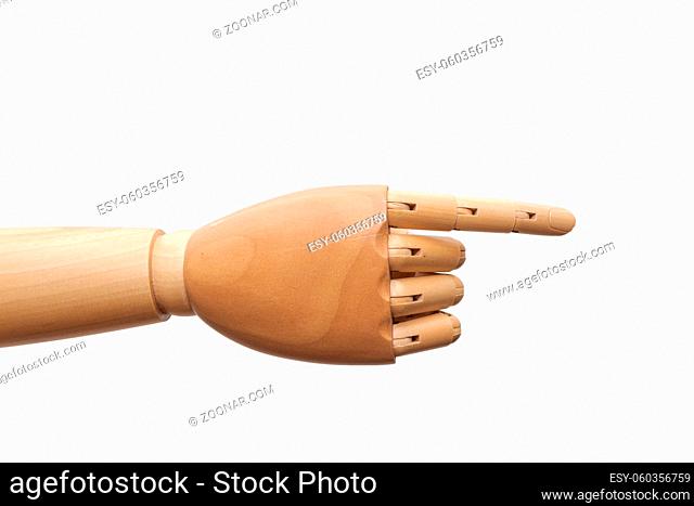Right hand of wooden dummy mannequin pointing to the right with index finger on white background