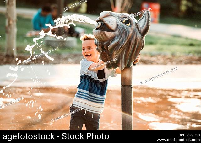 A young boy at a spray park; Edmonton, Alberta, Canada