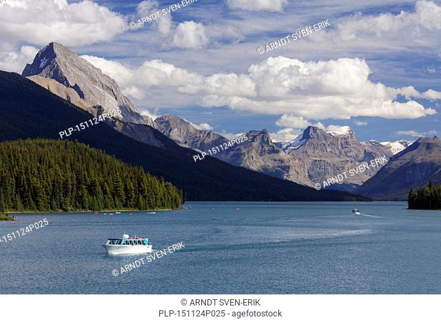 Canoes and tourist boat on Maligne Lake in the Jasper National Park, Alberta, Canadian Rockies, Canada