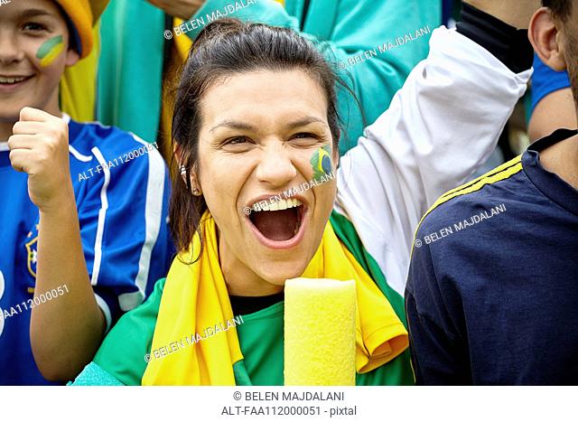 Brazilian football fan cheering at match