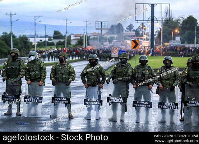 19 June 2022, Ecuador, Quito: Members of the armed forces block the access to the E35 highway for a protest march by hundreds of indigenous people from the...