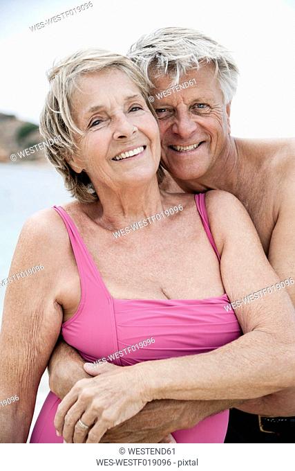 Spain, Senior couple embracing on beach
