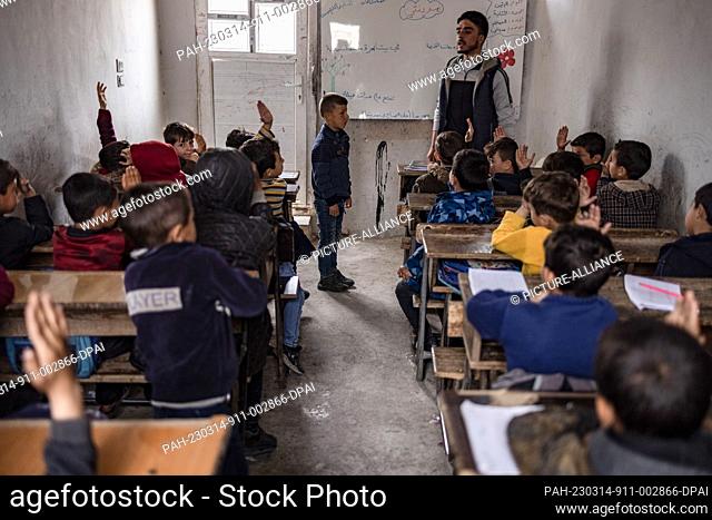 14 March 2023, Syria, Mashhad Ruhin: Syrian children, mostly orphans, attend a class at the school of Mashhad Ruhin camp