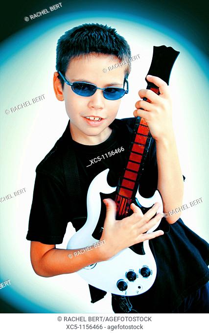 9 years old boy playing guitar