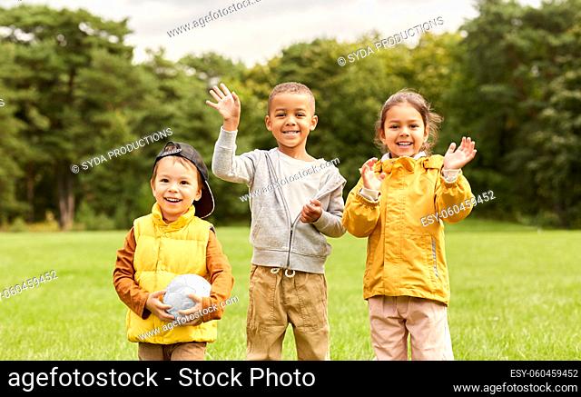 happy children with soccer ball at park