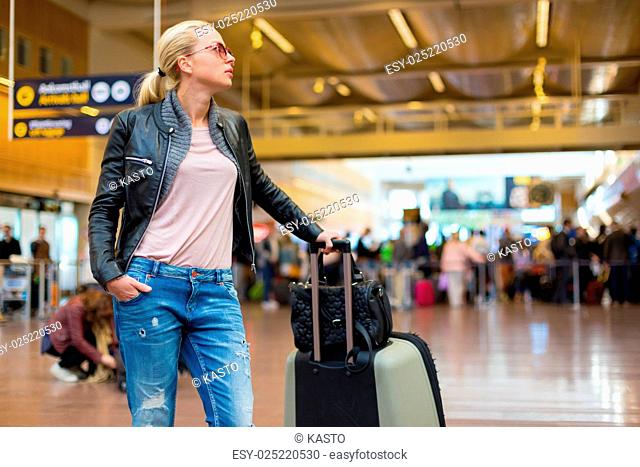 Female traveller checking flight departures board