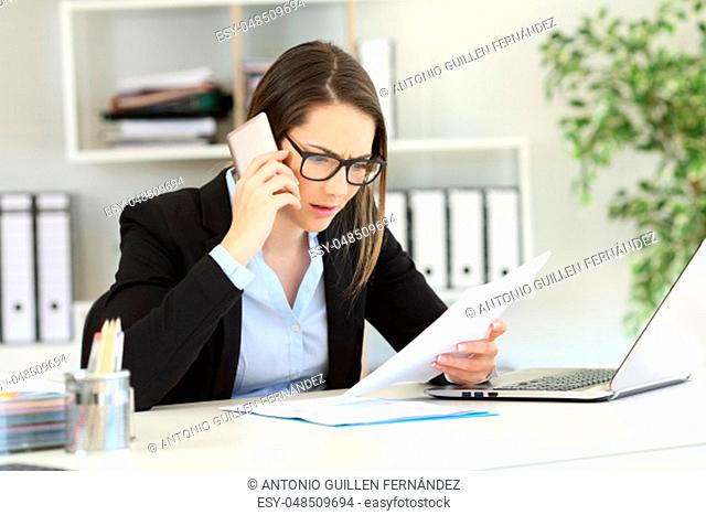Confused customer calling support service with a smart phone at office