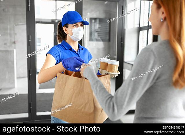 delivery girl in mask giving paper bag to customer