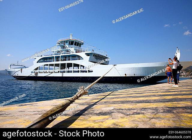 Glyfa village, Greece - August 15, 2023: Ferryboat docked at the harbour of Glyfa village in Greece. Aegean sea transport and cargo ships