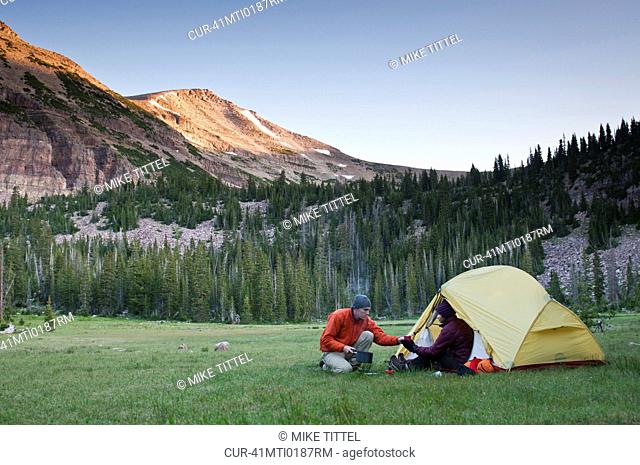 Hikers camping in rural landscape
