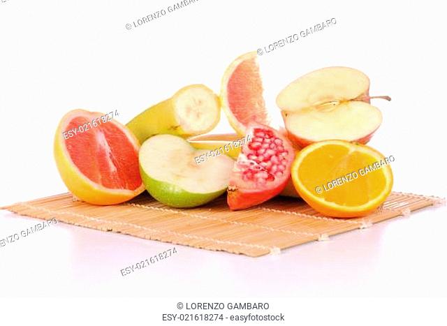 slices of different fruits on a bamboo place mat