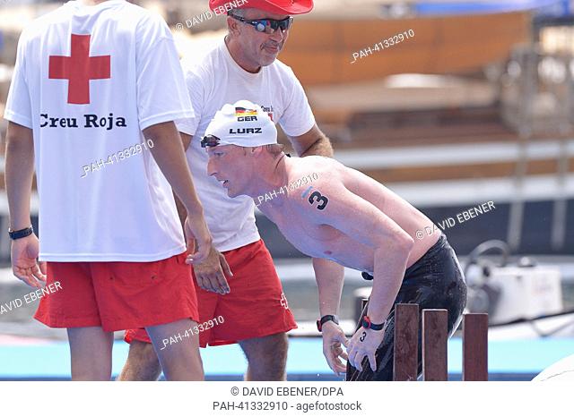 Gold medalist Thomas Lurz of Germany is been helped out of the water by the Red Cross after the men's 25 km Marathon Open Water event of the 15th FINA Swimming...
