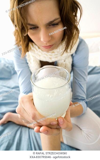 Young woman taking aspirine