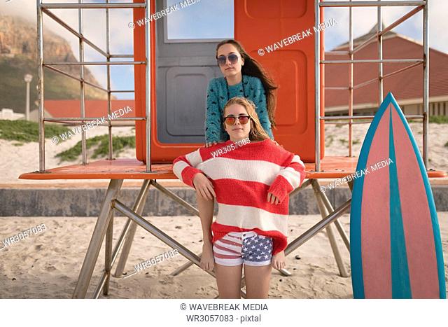 Two female relaxing on lifeguard cabin