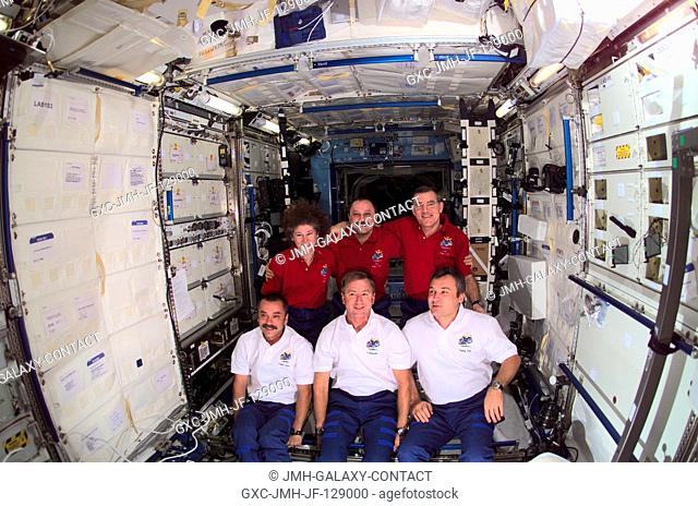 The Expedition Two (back row) and Expedition Three crews assemble for a group photo in the Destiny laboratory on the International Space Station (ISS)