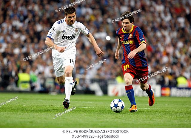 Messi with the ball marked by Xabi Alonso and Sergio Ramos, UEFA Champions League Semifinals game between Real Madrid and FC Barcelona, Bernabeu Stadiumn