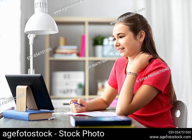 student girl with tablet pc learning at home