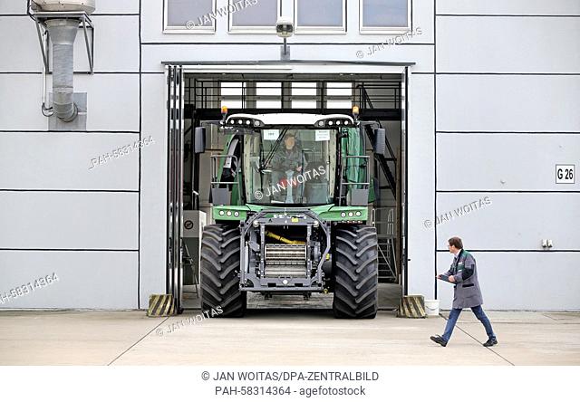 Two employees do the quality check of a Fendt Katana 65 corn chopper in front of a former tank maintenance hall in Hohenmoelsen, Germany, 17 April 2015