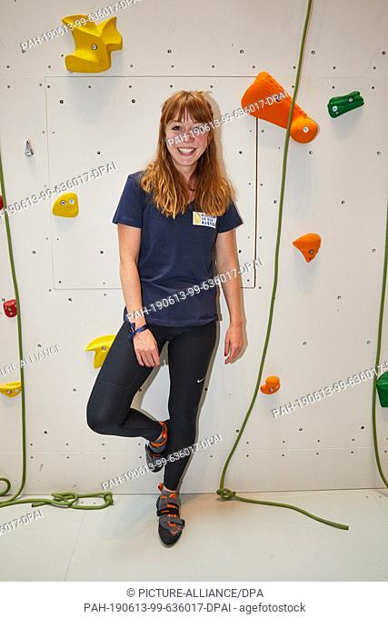 13 June 2019, Hamburg: Joanna Semmelrogge, actress, is standing at the climbing wall in the Europa Passage climbing with a celebrity