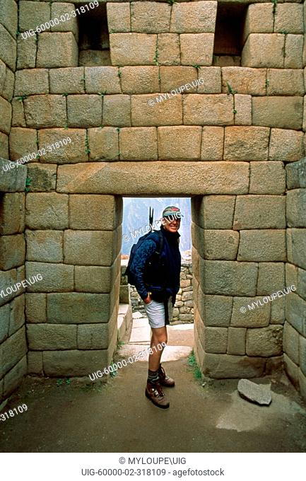 Tourist at the INCA RUINS of MACHU PICCHU - PERUVIAN ANDES