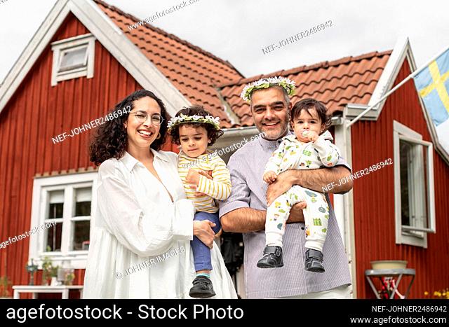 Parents with kids wearing flower wreaths