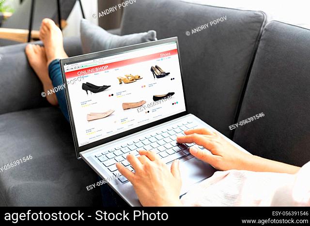 Woman Online Ecommerce Shopping Using Laptop On Sofa
