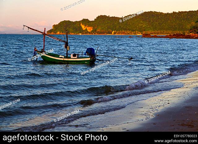sunrise asia in the lomprayah bay isle white beach  rocks boat  thailand and south china sea anchor
